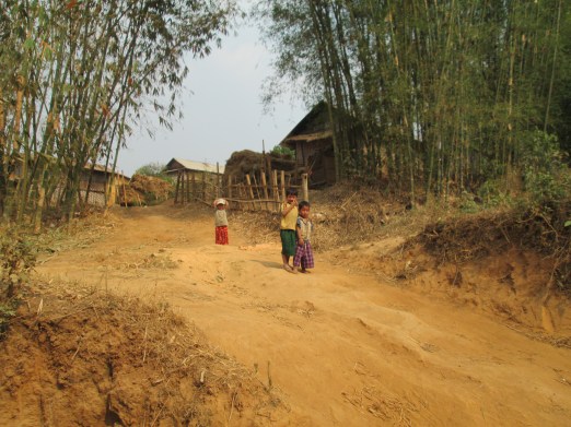 Passing by villages and children coming out to greet us.